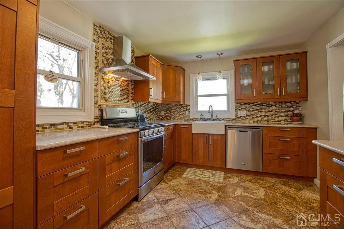 91 River Road Sayreville, NJ 08872 - Photo 8 of 36 Renovated kitchen, tiled floor, farm sink, quartz countertops and tiled backsplash.