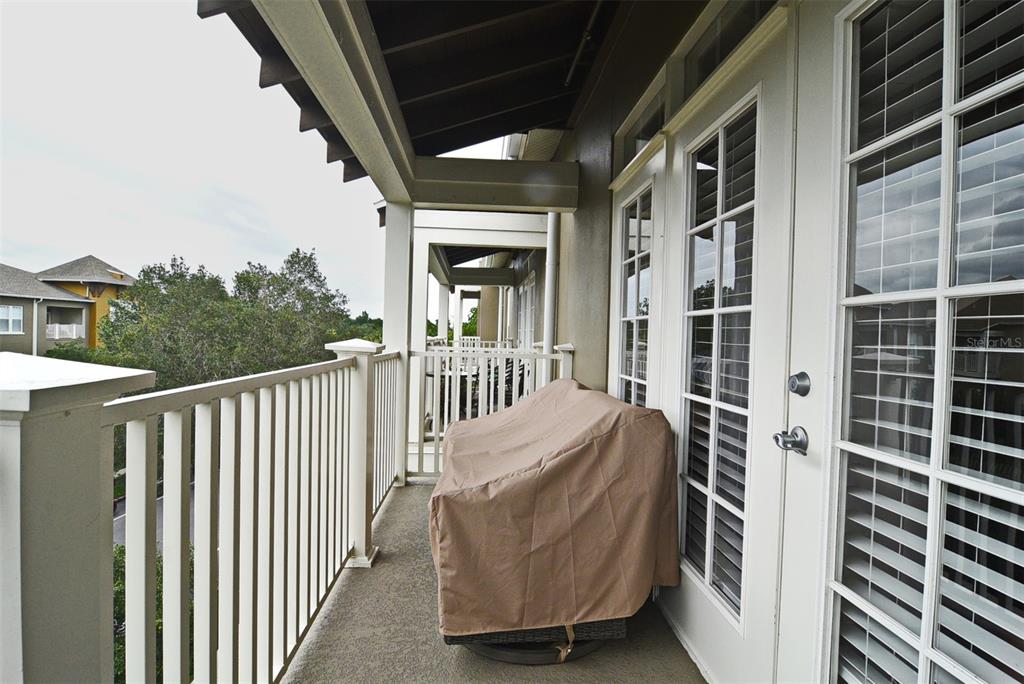 1400 Celebration Avenue, Unit 406 Celebration, FL 34747 - Photo 11 of 51 a view of a balcony with wooden floor and fence