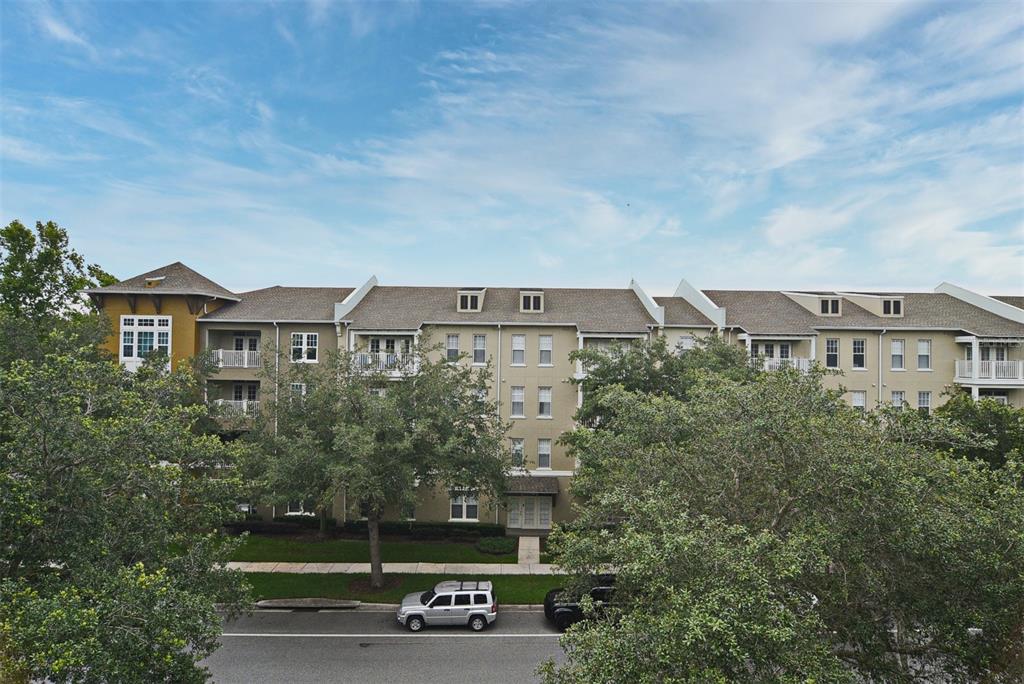1400 Celebration Avenue, Unit 406 Celebration, FL 34747 - Photo 12 of 51 a view of a building in front of a yard