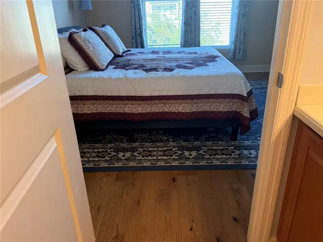 a bedroom with a bed and painting on the wall