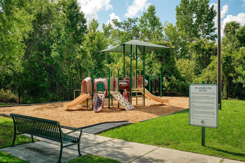 1400 Celebration Avenue, Unit 406 Celebration, FL 34747 - Photo 48 of 51 a view of backyard with a slide and table