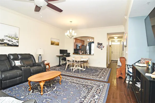 a living room with furniture a chandelier and a table