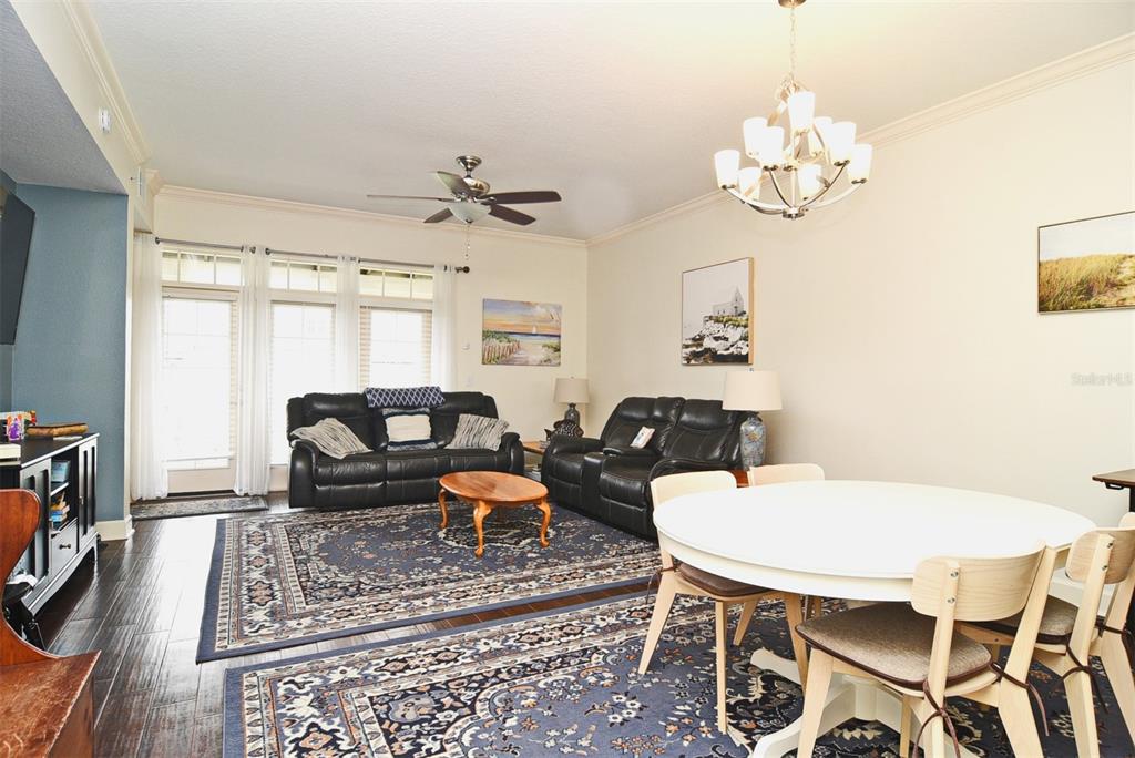 1400 Celebration Avenue, Unit 406 Celebration, FL 34747 - Photo 8 of 51 a living room with furniture a chandelier and a table