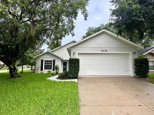 a front view of house with yard and green space