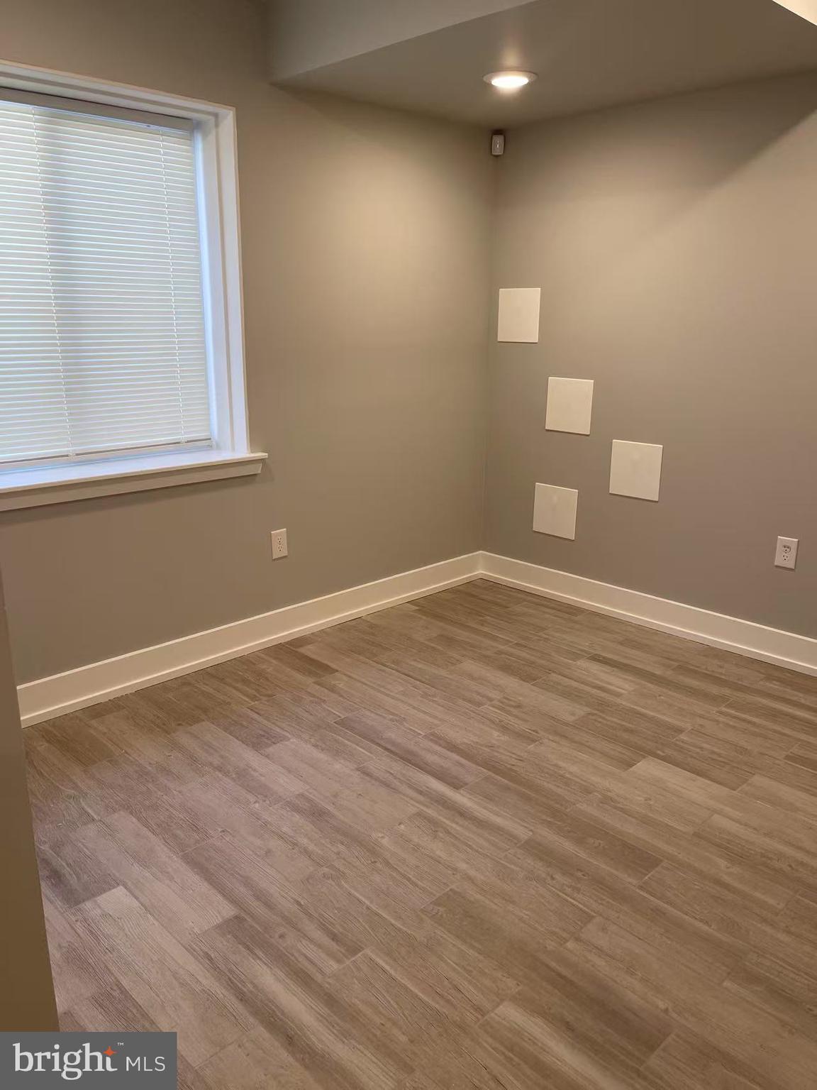 1505 Parrish Street, Unit A Philadelphia, PA 19130 - Photo 11 of 21 a view of empty room with wooden floor and fan