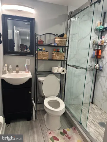 a bathroom with a toilet a sink and a mirror