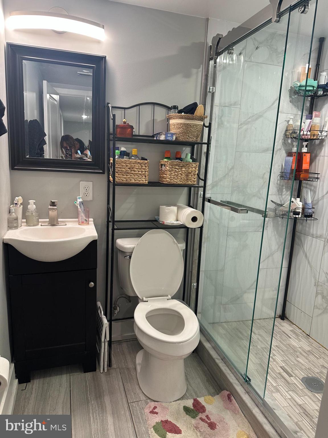 1505 Parrish Street, Unit A Philadelphia, PA 19130 - Photo 14 of 21 a bathroom with a toilet a sink and a mirror