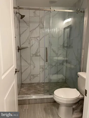 a bathroom with a toilet and a shower