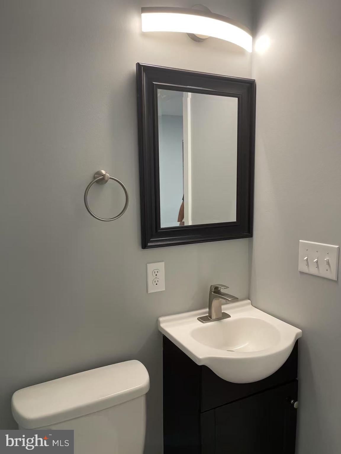 1505 Parrish Street, Unit A Philadelphia, PA 19130 - Photo 19 of 21 a bathroom with a toilet sink and mirror