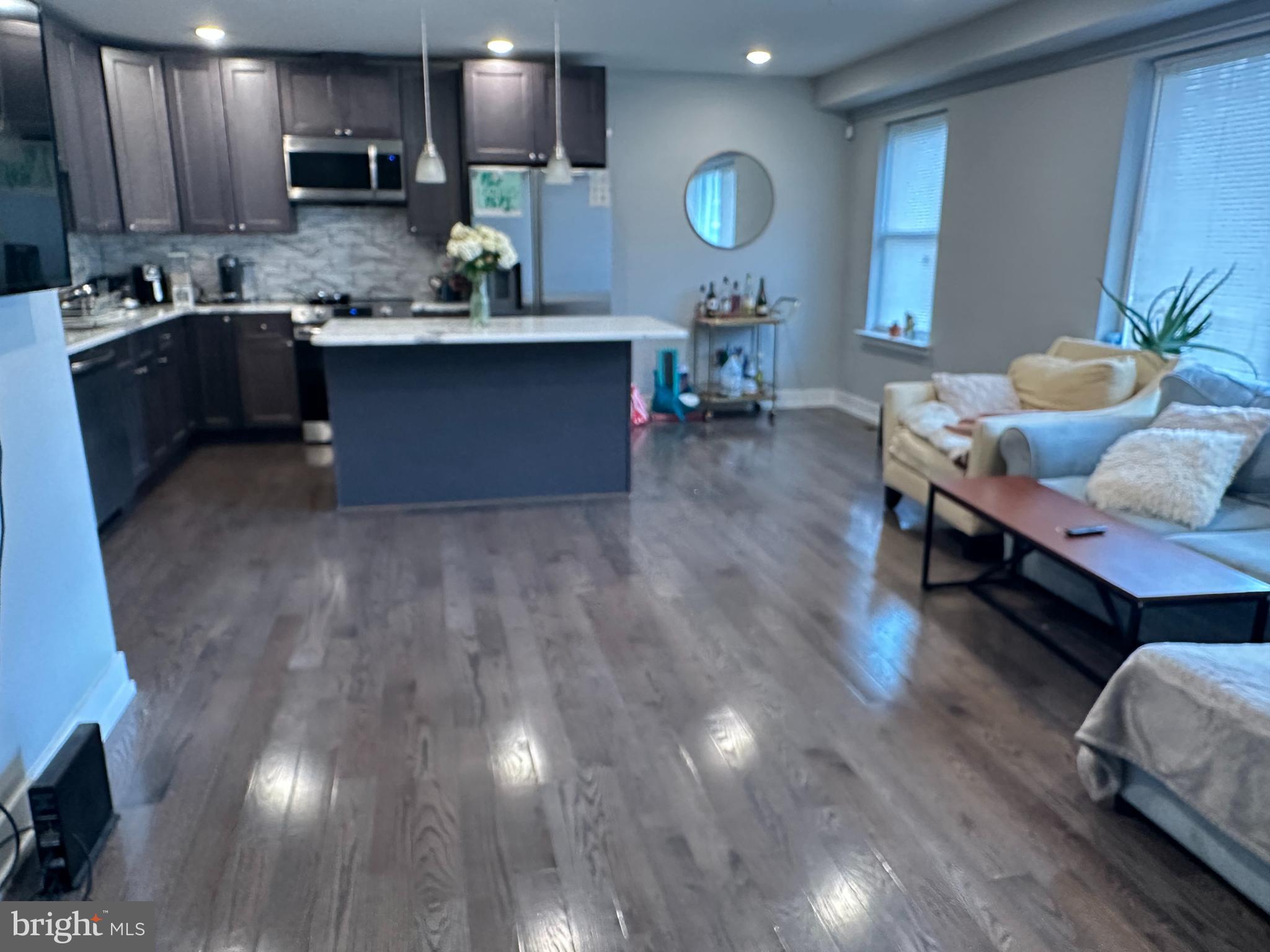 1505 Parrish Street, Unit A Philadelphia, PA 19130 - Photo 6 of 21 a living room with stainless steel appliances granite countertop furniture a wooden floor and a sink