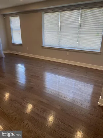 a view of wooden floor and windows in a room