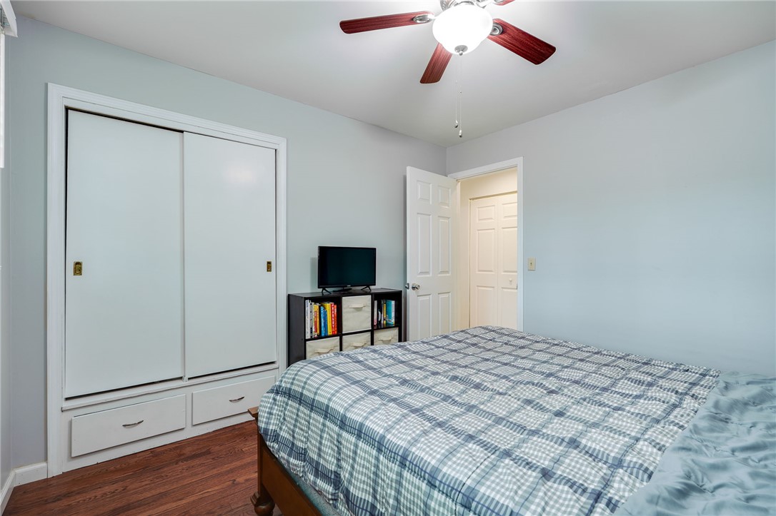 6950 Red Lion 5 Points Road Springboro, OH 45066 - Photo 33 of 78 This cozy bedroom features warm hardwood flooring and practical closet storage for comfortable living.