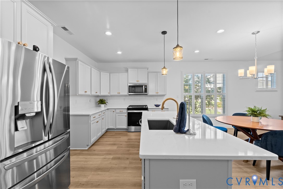 8819 Roberta Road Mechanicsville, VA 23116 - Photo 29 of 79 Contemporary kitchen featuring white cabinetry, st