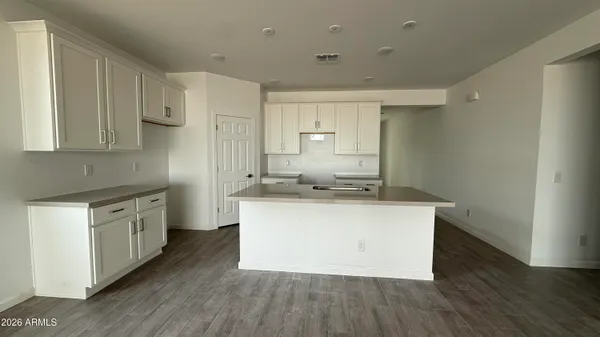 a kitchen with stainless steel appliances a sink stove and wooden floor