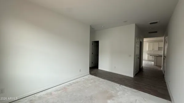 an empty room with windows and closet