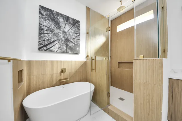 a bathroom with a tub and shower