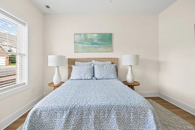 a bed room with a bed and a night stand