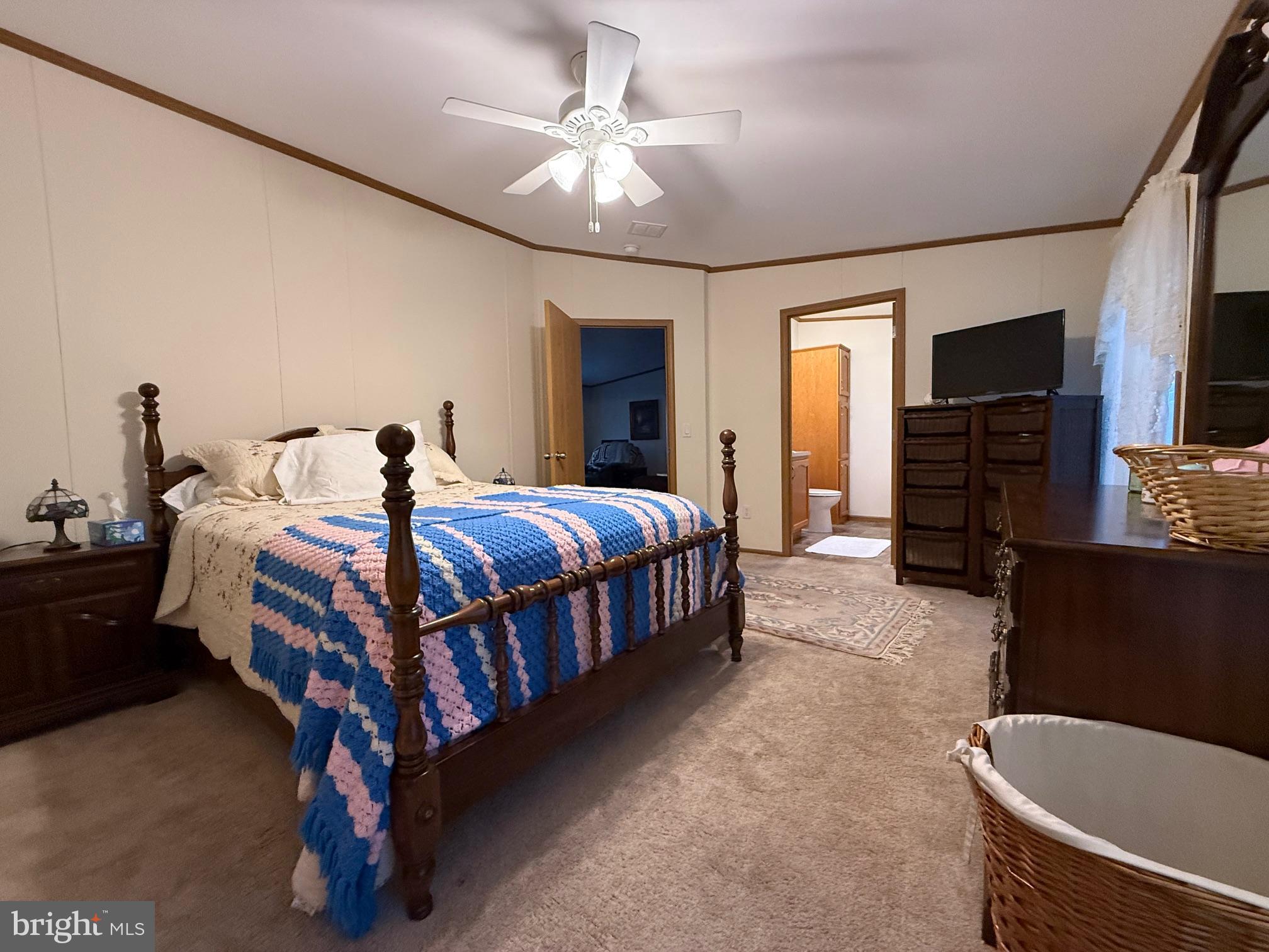 9347 Colonial Mill Drive Delmar, MD 21875 - Photo 13 of 33 a bedroom with a bed and a chandelier