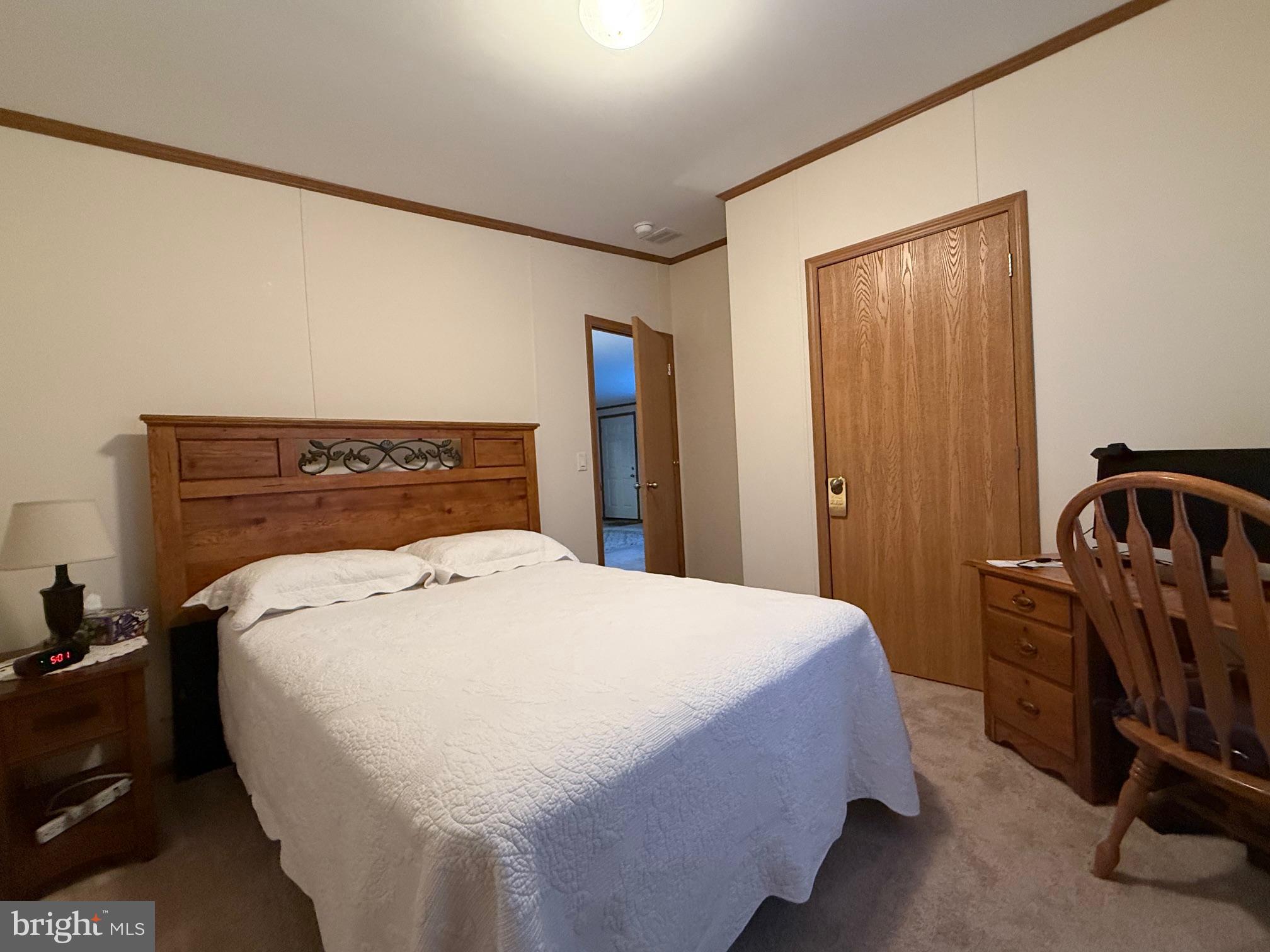 9347 Colonial Mill Drive Delmar, MD 21875 - Photo 18 of 33 a bed sitting in a bedroom next to a window