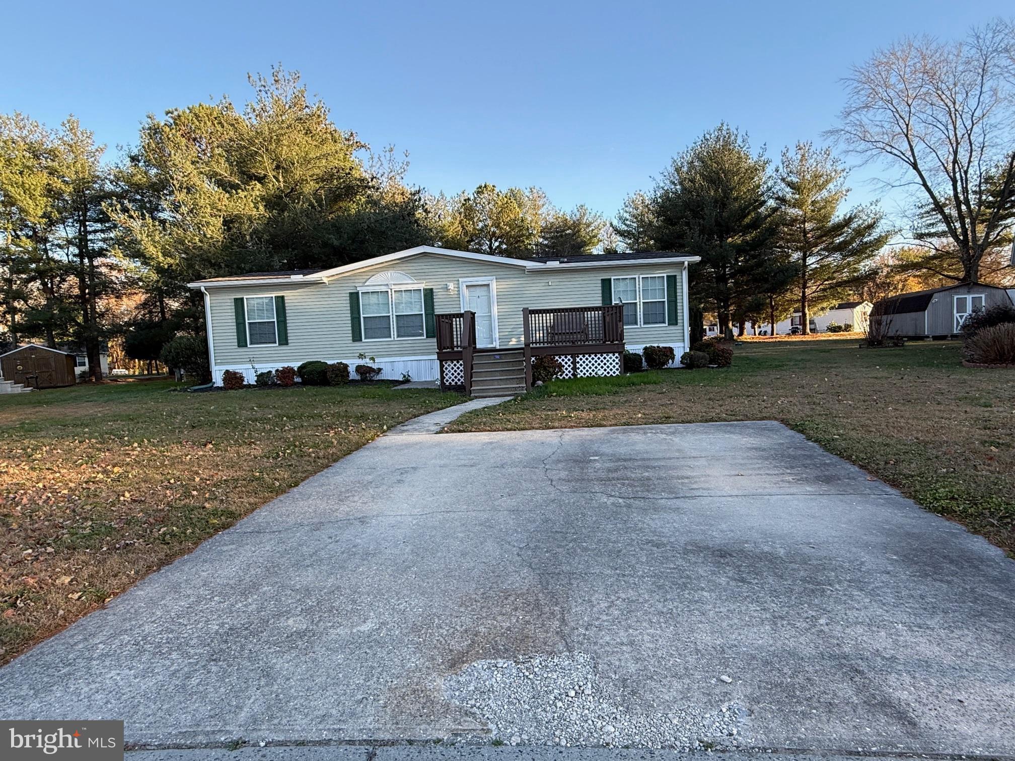 9347 Colonial Mill Drive Delmar, MD 21875 - Photo 2 of 33 a front view of a house with a yard and trees