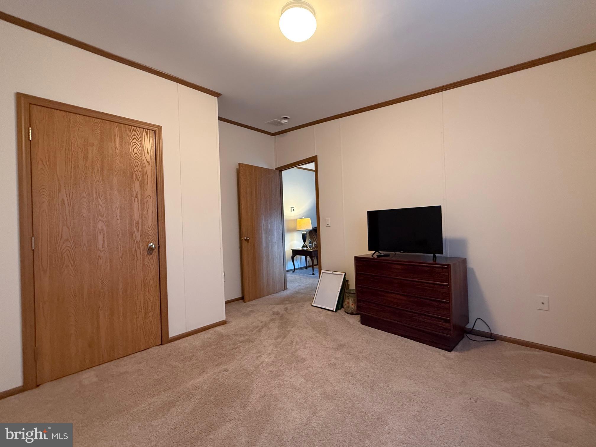 9347 Colonial Mill Drive Delmar, MD 21875 - Photo 22 of 33 a bedroom with a bed and a television