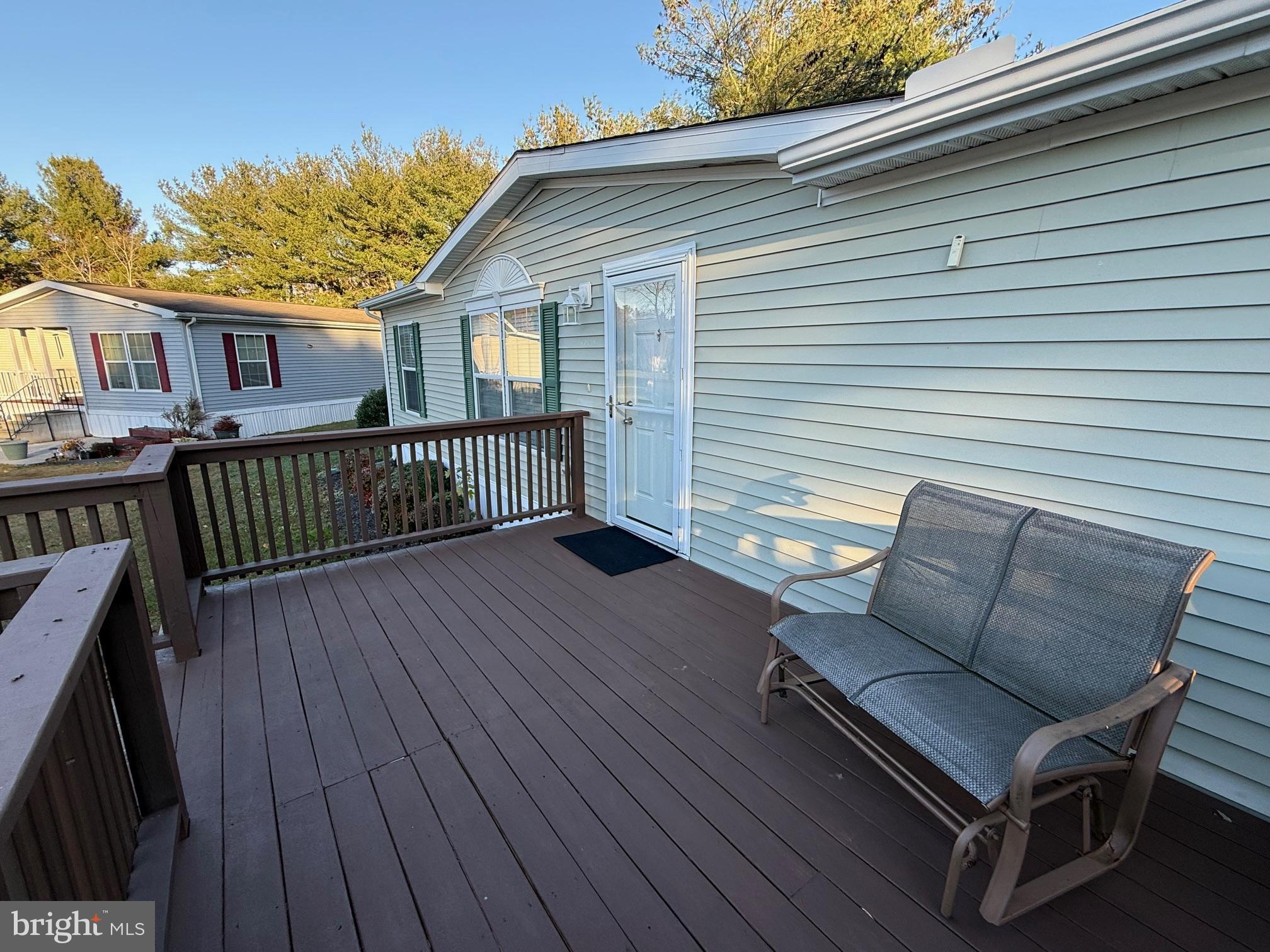 9347 Colonial Mill Drive Delmar, MD 21875 - Photo 23 of 33 a view of a roof deck with wooden floor and fence