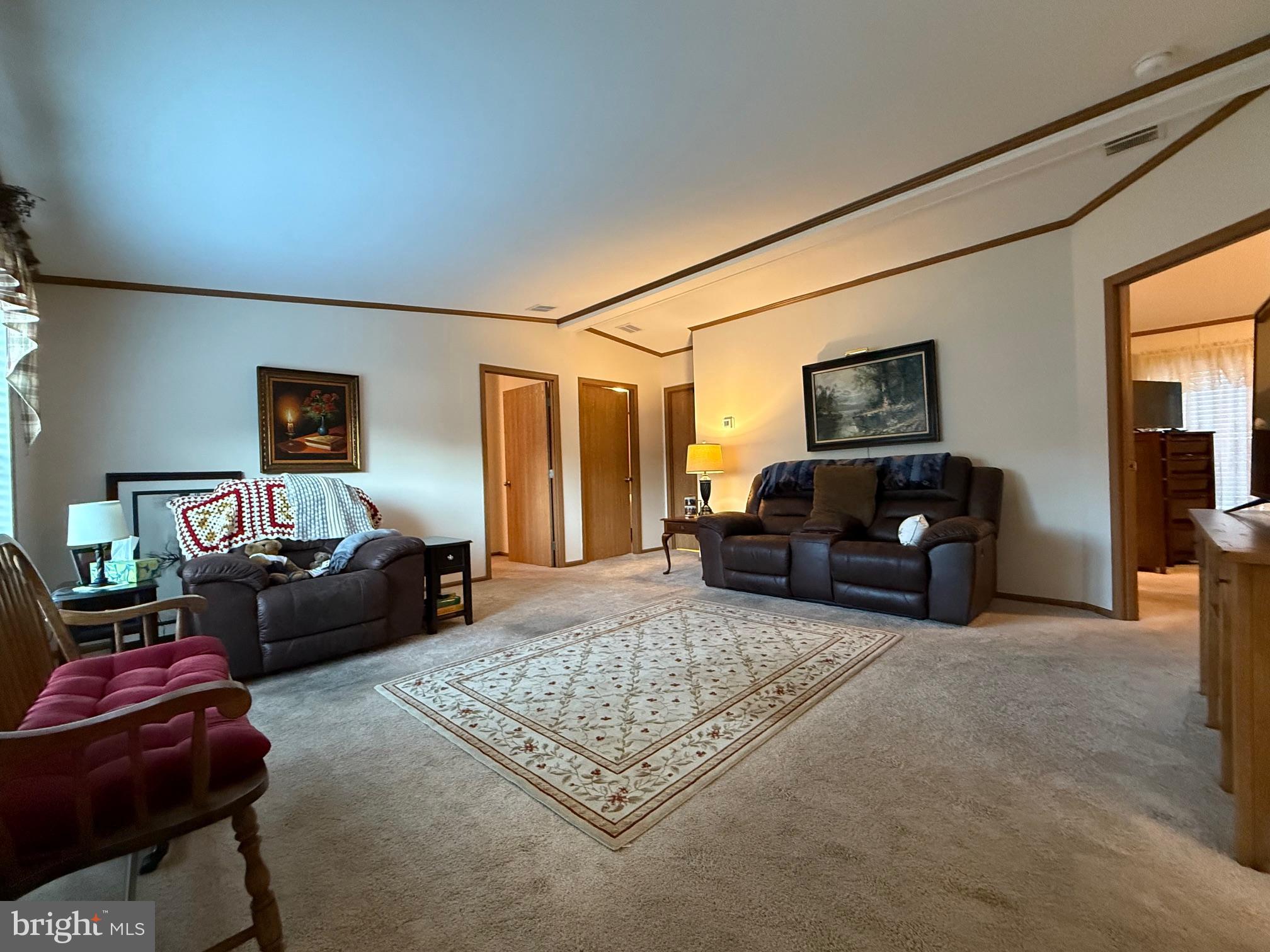 9347 Colonial Mill Drive Delmar, MD 21875 - Photo 4 of 33 a living room with furniture a flat screen tv and a couch