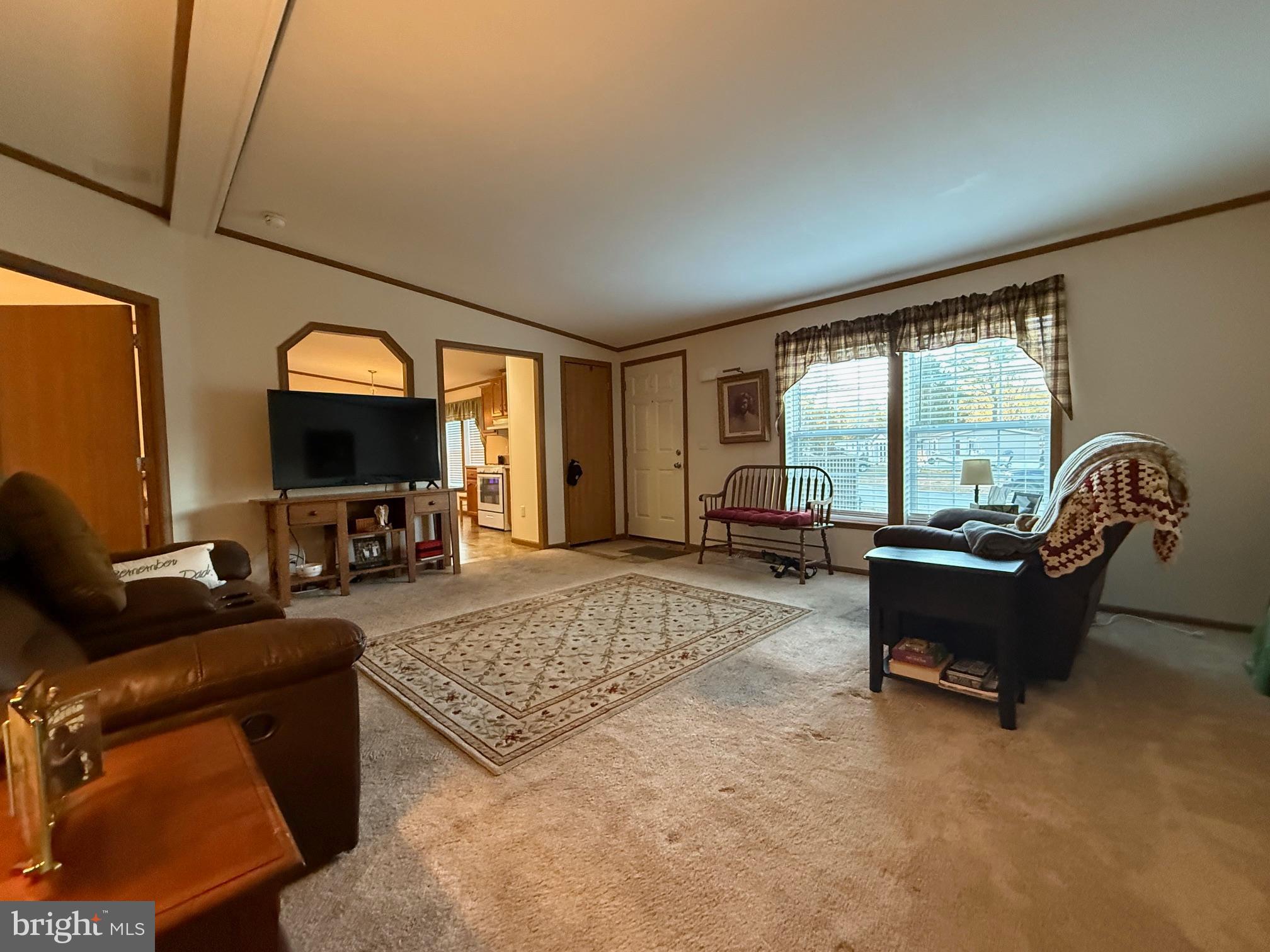 9347 Colonial Mill Drive Delmar, MD 21875 - Photo 6 of 33 a living room with furniture and a flat screen tv