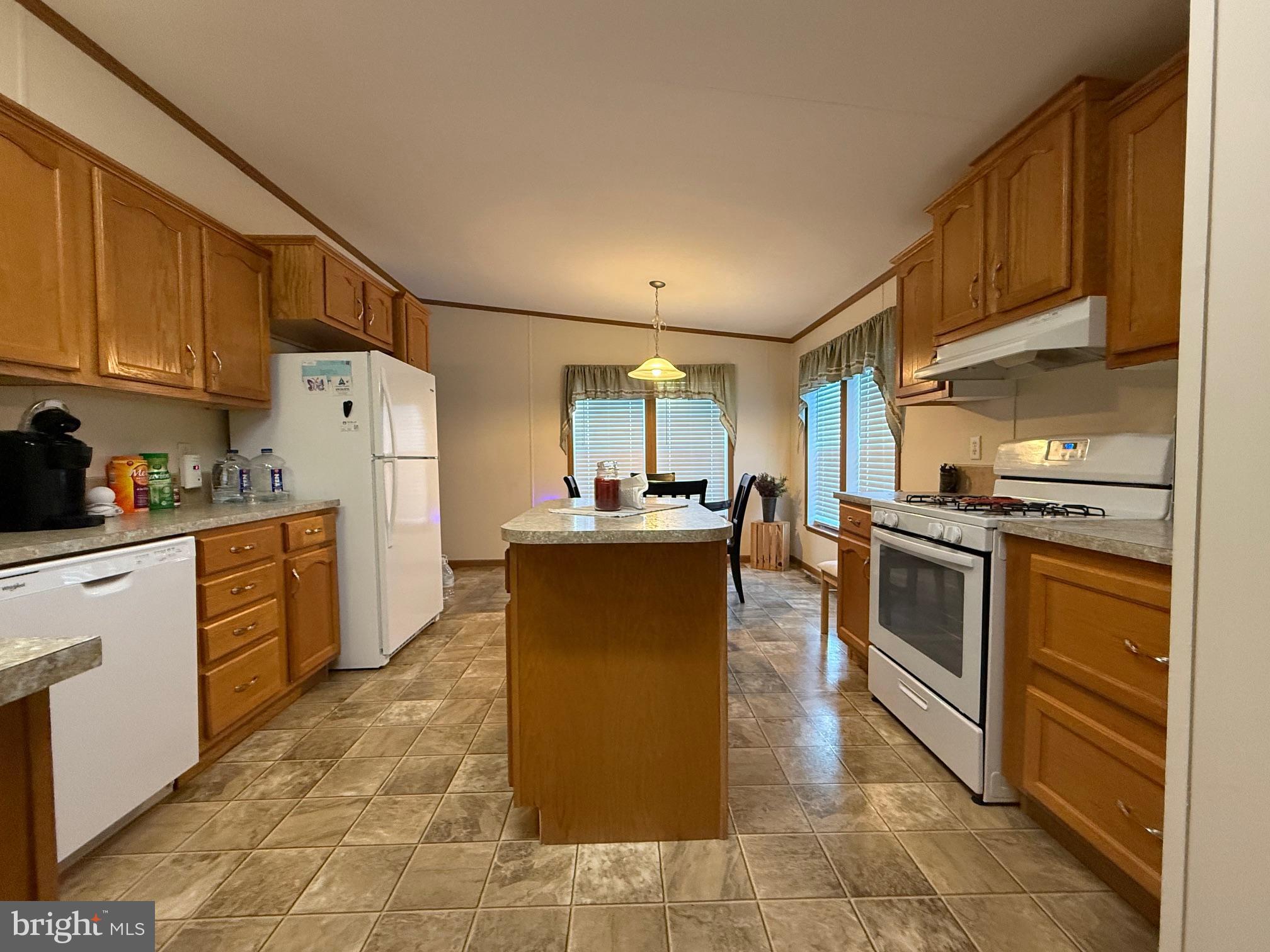 9347 Colonial Mill Drive Delmar, MD 21875 - Photo 7 of 33 a kitchen with a refrigerator sink and cabinets