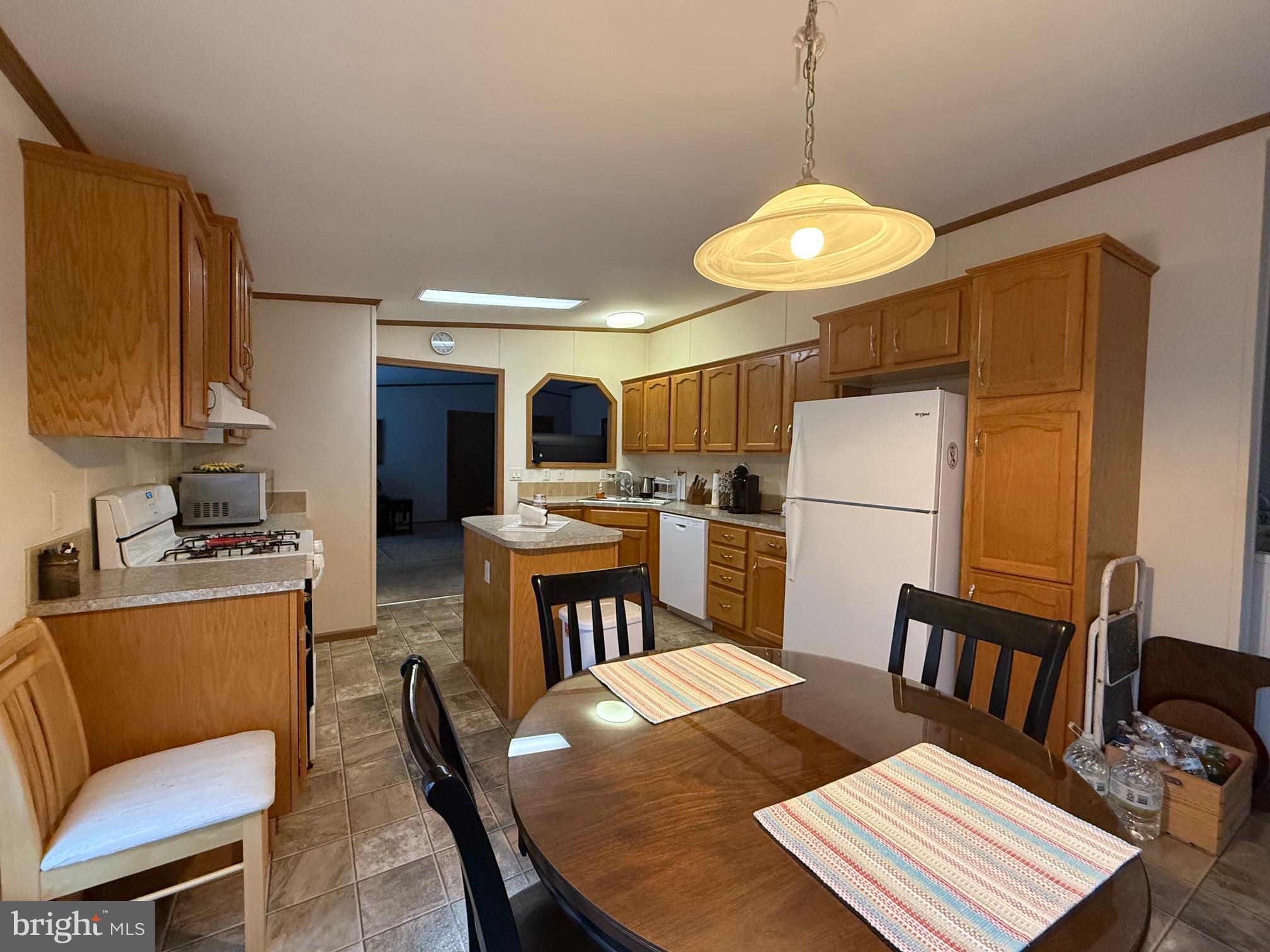9347 Colonial Mill Drive Delmar, MD 21875 - Photo 8 of 33 a open kitchen with refrigerator stove and a dining table