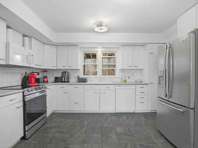 a kitchen with granite countertop cabinets and stainless steel appliances