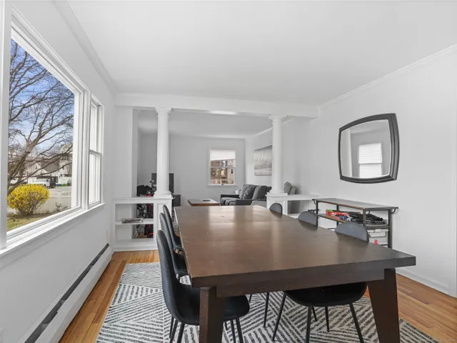 a view of a dining room with furniture and wooden floor