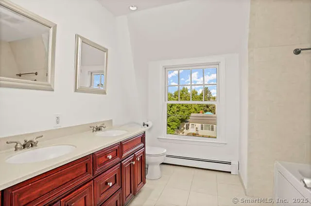a bathroom with a sink double vanity and a bathtub