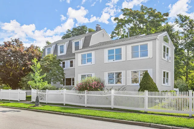 a view of a brick house next to a yard