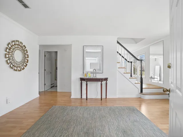 a view of an entryway with wooden floor