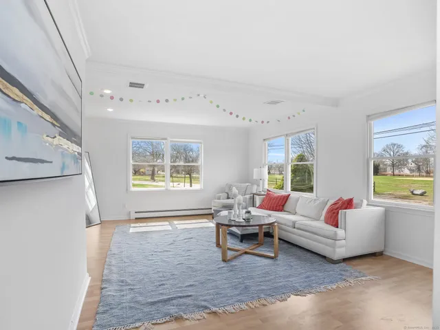 a living room with furniture and a large window