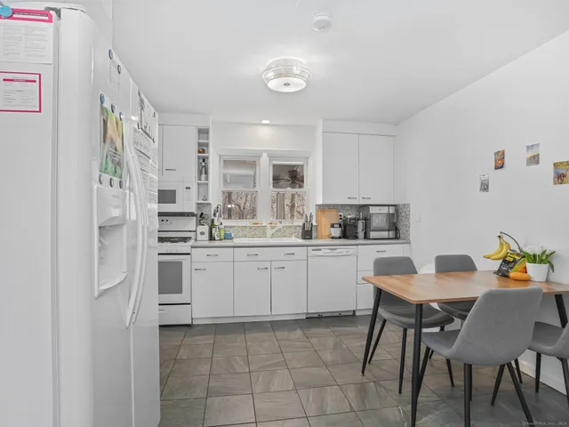 a kitchen with cabinets and chairs