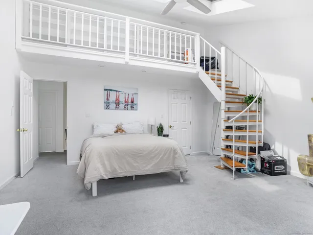 a view of bedroom with furniture and staircase