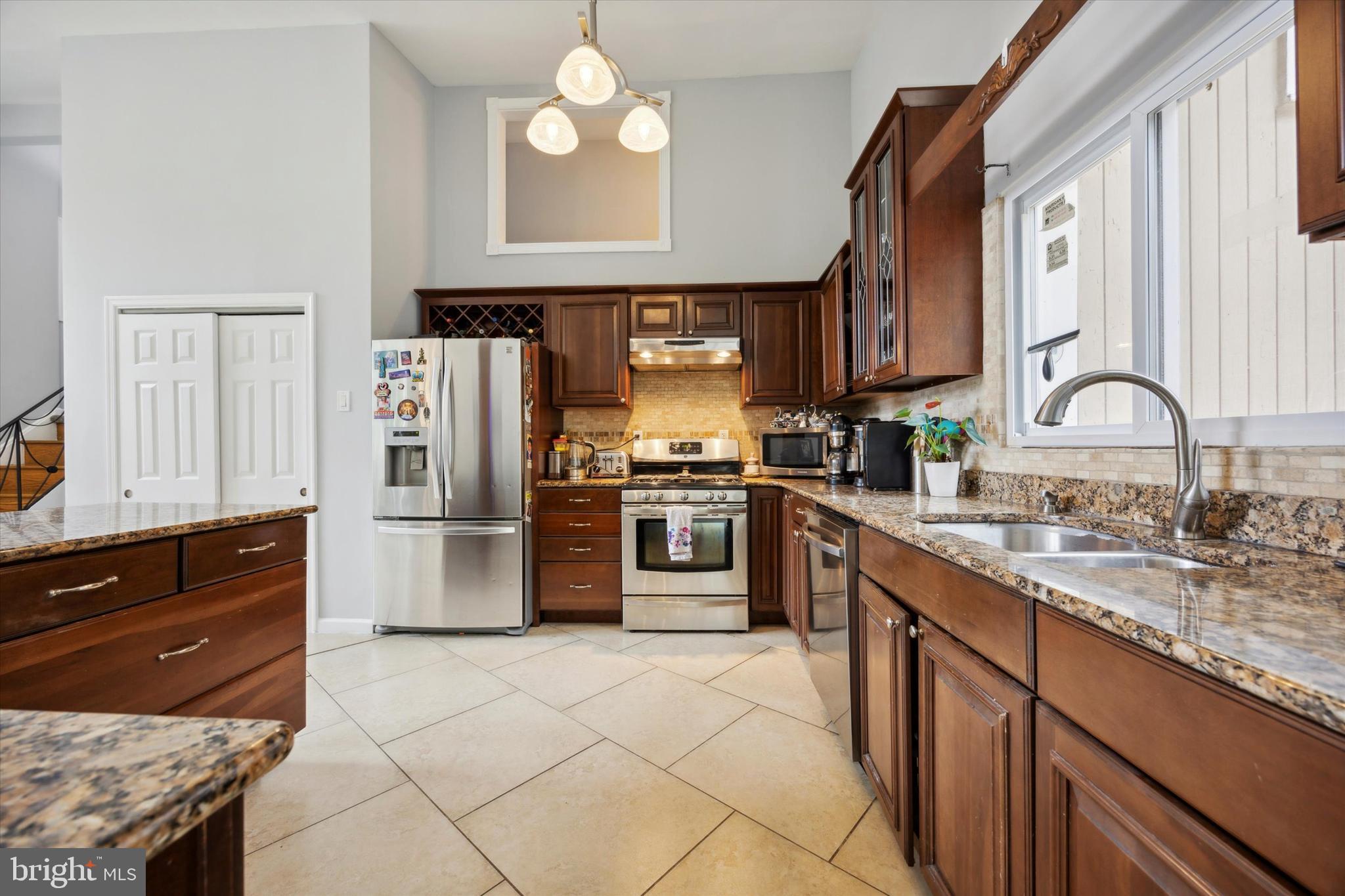 160 Yew Road Cheltenham, PA 19012 - Photo 8 of 24 a kitchen with stainless steel appliances granite countertop a stove a sink and a refrigerator