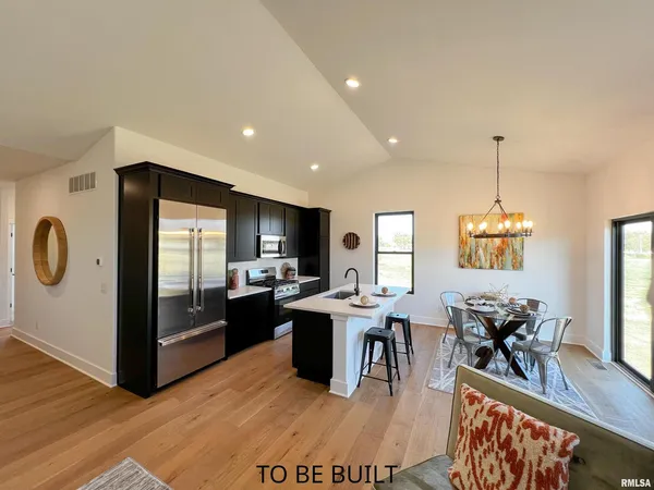 a view of a hallway with wooden floor and cabinet