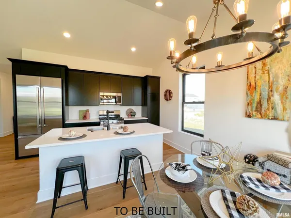 a kitchen with a sink a stove and chairs