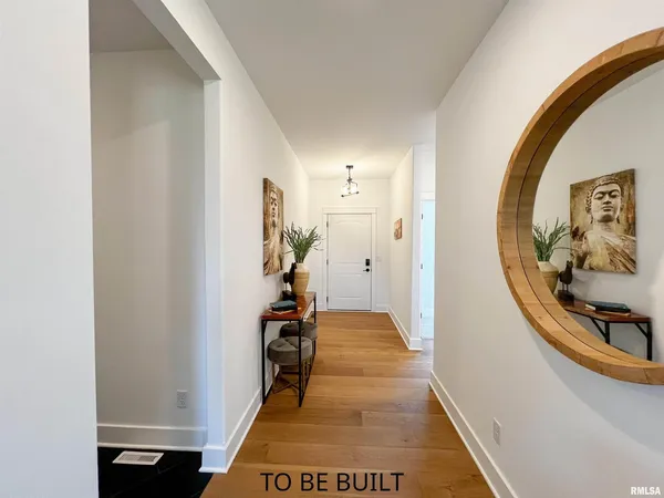 a view of a hallway to a livingroom and a dining room with furniture