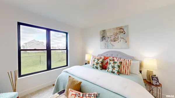 a bed sitting in a bedroom next to a window