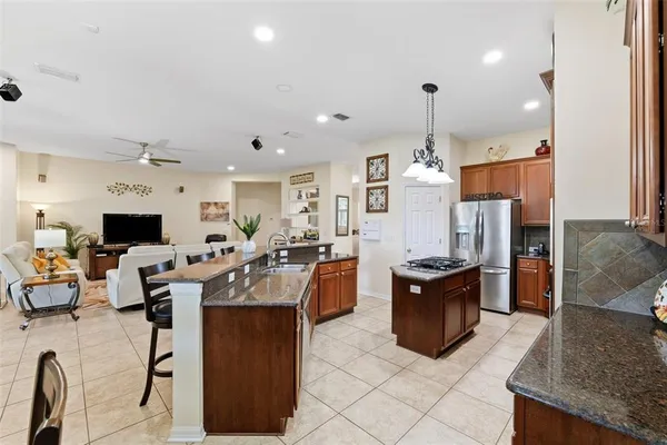 a kitchen with stainless steel appliances a stove a sink and a refrigerator