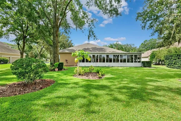 a view of house with backyard