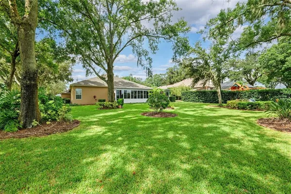 a view of garden with trees in the background