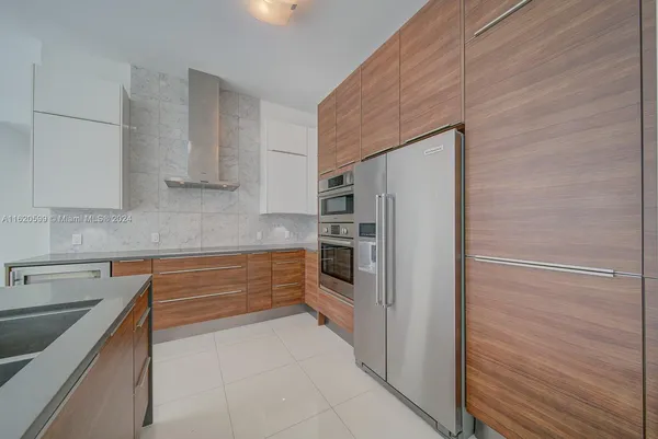a kitchen with stainless steel appliances a refrigerator and cabinets