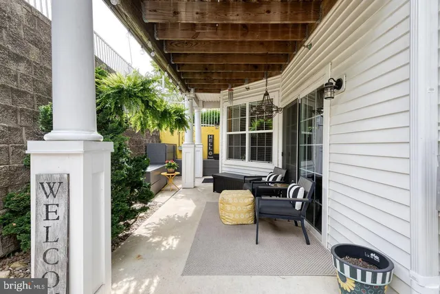 a view of a patio with table and chairs and potted plants with wooden floor