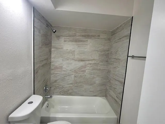 a bathroom with a tub and a shower