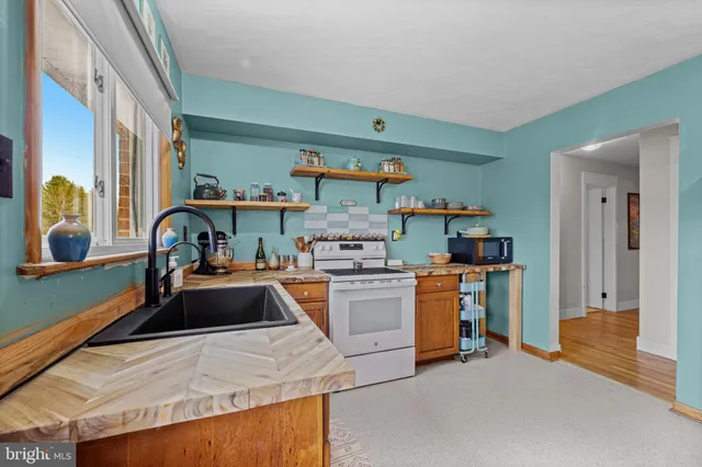 a kitchen with a sink and a stove top oven